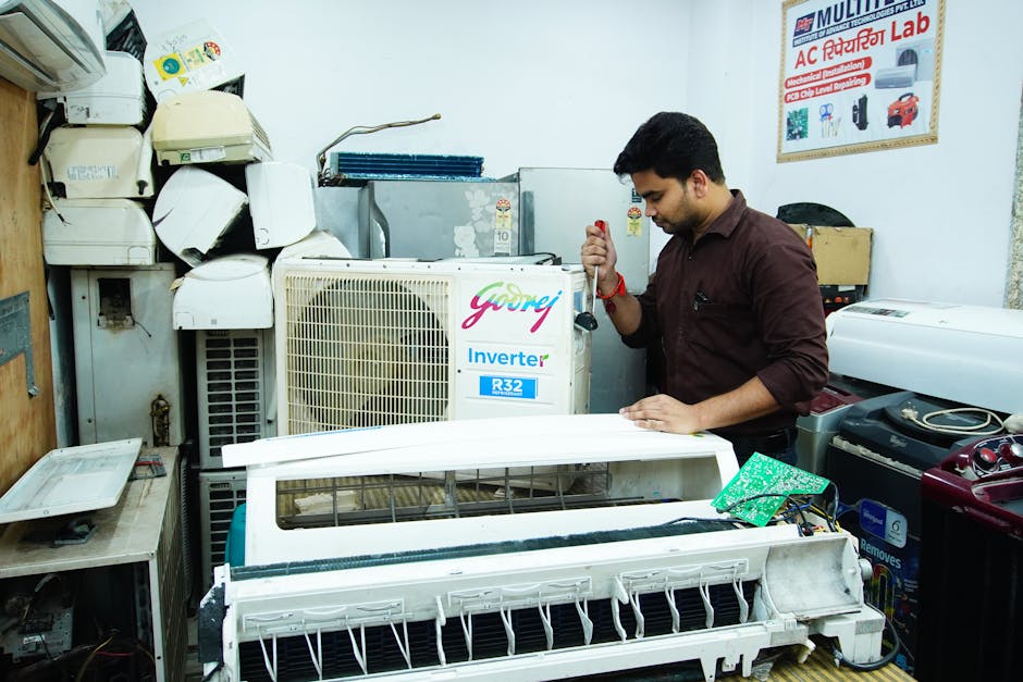 HVAC technician repairing an air conditioning unit